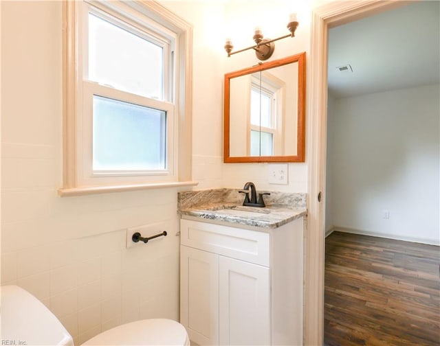 8014 E Glen Rd, Norfolk, VA 23505 - bathroom featuring toilet, healthy amount of natural light, vanity, and wood finished floors