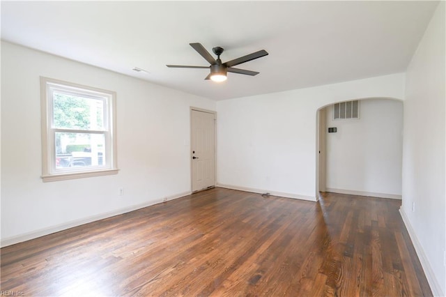 8014 E Glen Rd, Norfolk, VA 23505 - spare room with arched walkways, ceiling fan, dark wood-type flooring, and baseboards