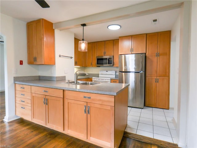 8014 E Glen Rd, Norfolk, VA 23505 - kitchen featuring stainless steel appliances, a peninsula, a sink, light wood-style floors, and baseboards