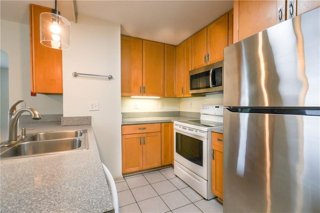 8014 E Glen Rd, Norfolk, VA 23505 - kitchen featuring stainless steel appliances, a sink, light tile patterned flooring, and brown cabinets