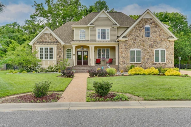 102 Ships Lndg, Carrollton, VA 23314 - view of front facade featuring stone siding, covered porch, french doors, and a front lawn