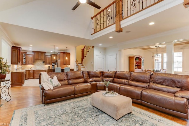102 Ships Lndg, Carrollton, VA 23314 - living area with stairway, a ceiling fan, a towering ceiling, light wood-style flooring, and ornamental molding