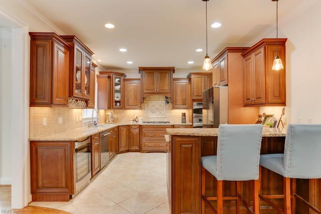 102 Ships Lndg, Carrollton, VA 23314 - kitchen with a peninsula, appliances with stainless steel finishes, brown cabinetry, light stone counters, and recessed lighting