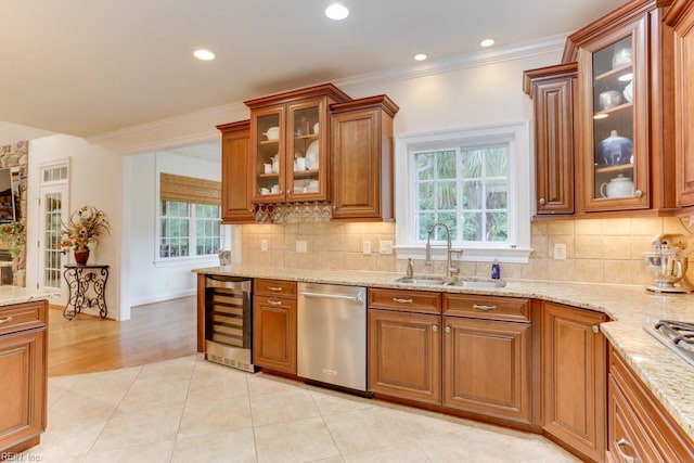 102 Ships Lndg, Carrollton, VA 23314 - kitchen with appliances with stainless steel finishes, wine cooler, a sink, brown cabinetry, and light stone countertops