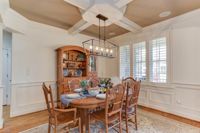 102 Ships Lndg, Carrollton, VA 23314 - dining room featuring a chandelier, beam ceiling, ornamental molding, a decorative wall, and light wood-style flooring