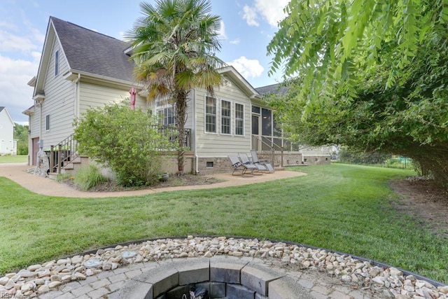 102 Ships Lndg, Carrollton, VA 23314 - view of grassy yard featuring a sunroom, a patio, and a fire pit