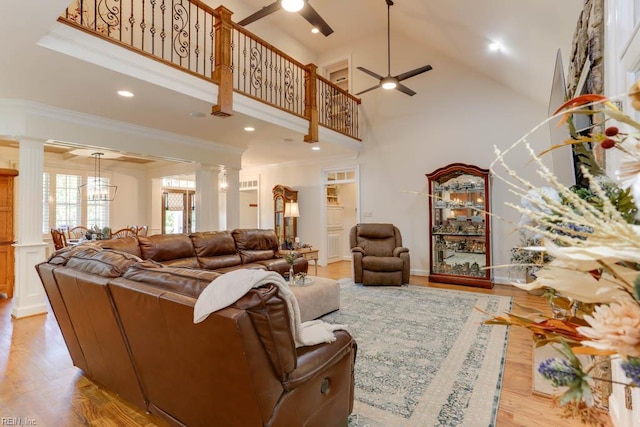102 Ships Lndg, Carrollton, VA 23314 - living area featuring ceiling fan, ornate columns, a high ceiling, ornamental molding, and light wood finished floors