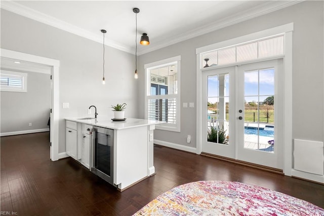 3527 Glencoe Ct, Chesapeake, VA 23322 - kitchen with a sink, crown molding, light countertops, dark wood-type flooring, and beverage cooler