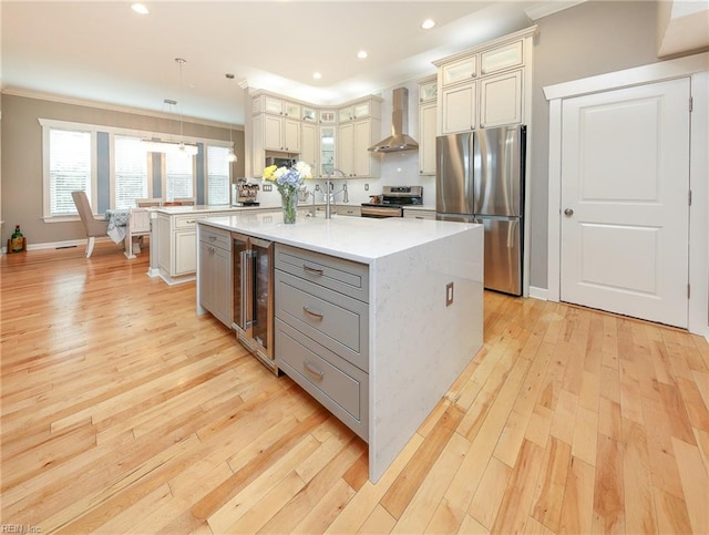 1920 Flintshire Dr, Chesapeake, VA 23323 - kitchen with appliances with stainless steel finishes, wall chimney range hood, wine cooler, crown molding, and a kitchen island with sink
