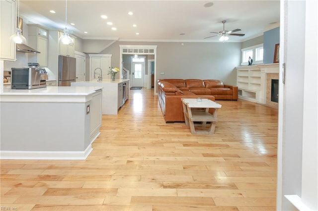 1920 Flintshire Dr, Chesapeake, VA 23323 - kitchen featuring ornamental molding, light countertops, ceiling fan, stainless steel refrigerator, and open floor plan