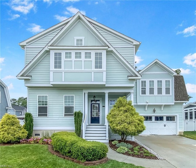 1920 Flintshire Dr, Chesapeake, VA 23323 - view of front of home with board and batten siding, concrete driveway, an attached garage, and a front lawn