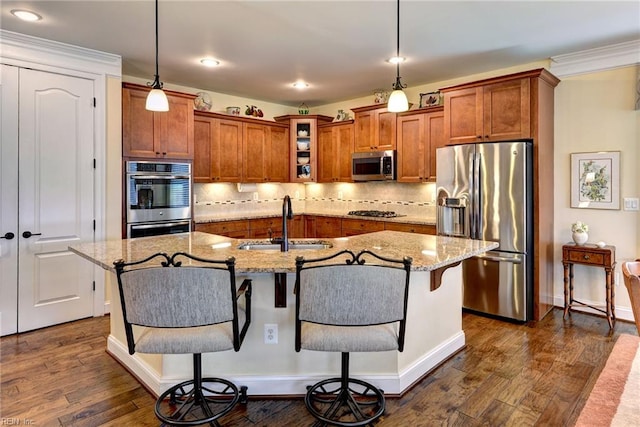 3907 Ethan Ln, Williamsburg, VA 23188 - kitchen featuring stainless steel appliances, a sink, brown cabinets, a kitchen bar, and recessed lighting