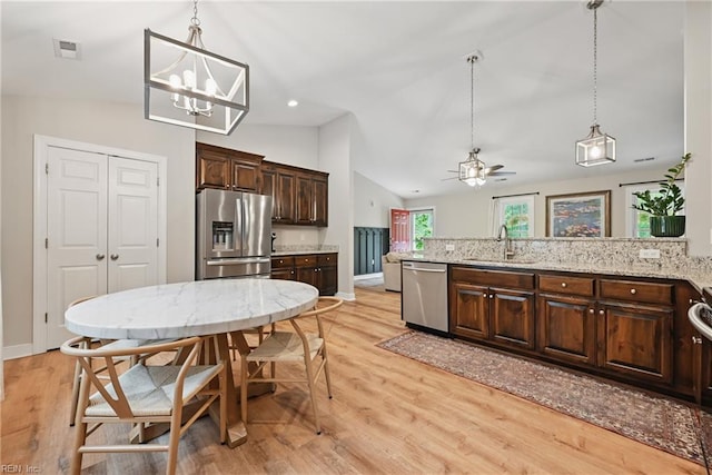 320 Pamunkey Ridge Rd, King William, VA 23086 - kitchen featuring stainless steel appliances, a sink, lofted ceiling, dark brown cabinetry, and decorative light fixtures