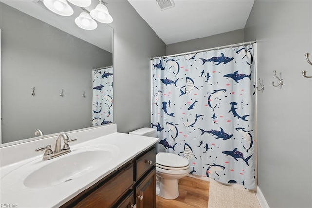 320 Pamunkey Ridge Rd, King William, VA 23086 - full bath featuring toilet, vanity, a shower with shower curtain, and wood finished floors
