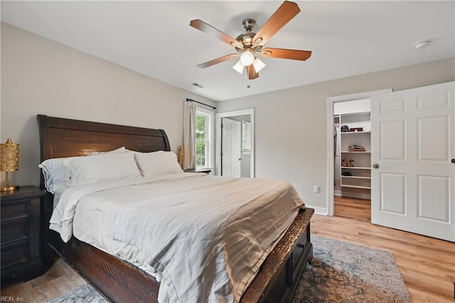 320 Pamunkey Ridge Rd, King William, VA 23086 - bedroom with light wood finished floors, ceiling fan, a spacious closet, and baseboards