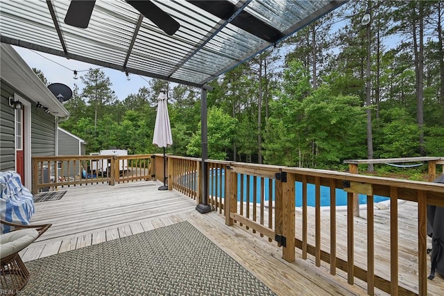 320 Pamunkey Ridge Rd, King William, VA 23086 - wooden deck featuring an outdoor pool, view of wooded area, and a pergola
