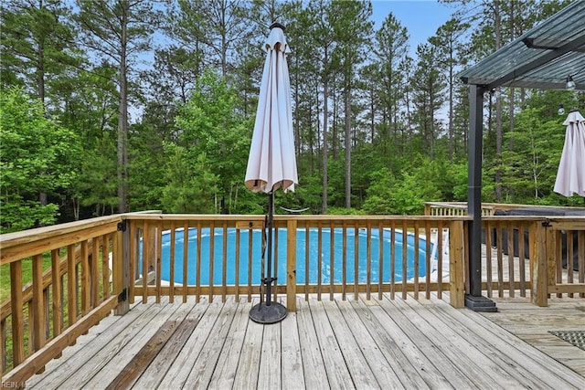 320 Pamunkey Ridge Rd, King William, VA 23086 - wooden deck with an outdoor pool and view of wooded area