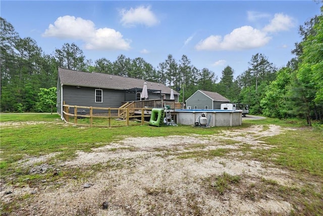 320 Pamunkey Ridge Rd, King William, VA 23086 - rear view of property with a wooden deck, an outdoor pool, a yard, and roof with shingles