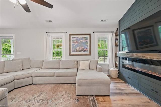 320 Pamunkey Ridge Rd, King William, VA 23086 - living area with a ceiling fan, wood finished floors, and a glass covered fireplace