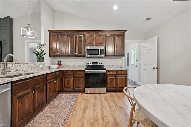 320 Pamunkey Ridge Rd, King William, VA 23086 - kitchen with appliances with stainless steel finishes, a sink, light wood finished floors, lofted ceiling, and light stone countertops