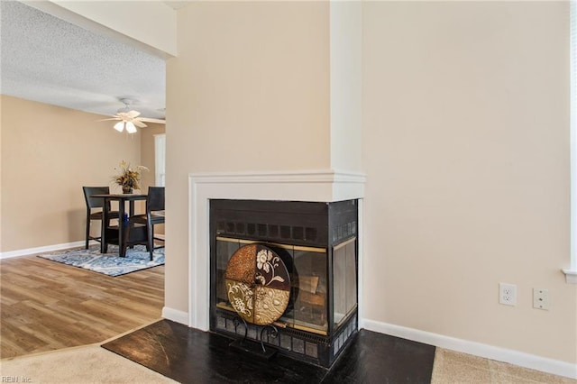 5113 Thatcher Way, Virginia Beach, VA 23456 - detailed view of a multi sided fireplace, a ceiling fan, baseboards, and wood finished floors