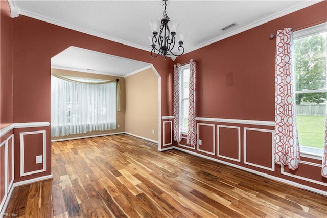 401 Fire Box Ct, Chesapeake, VA 23323 - unfurnished dining area with wood finished floors, plenty of natural light, a chandelier, arched walkways, and ornamental molding