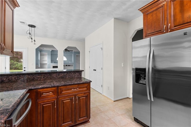 401 Fire Box Ct, Chesapeake, VA 23323 - kitchen featuring stainless steel appliances, light tile patterned flooring, dark stone counters, baseboards, and arched walkways