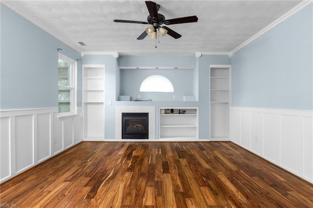 401 Fire Box Ct, Chesapeake, VA 23323 - unfurnished living room with built in features, a wainscoted wall, a ceiling fan, wood finished floors, and a tiled fireplace