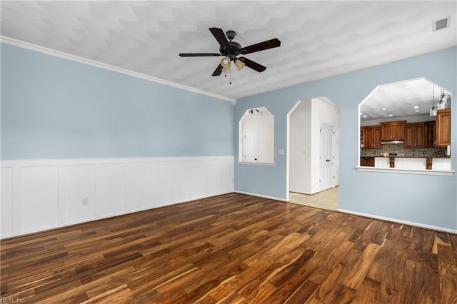 401 Fire Box Ct, Chesapeake, VA 23323 - unfurnished living room with ceiling fan, wood finished floors, wainscoting, ornamental molding, and arched walkways