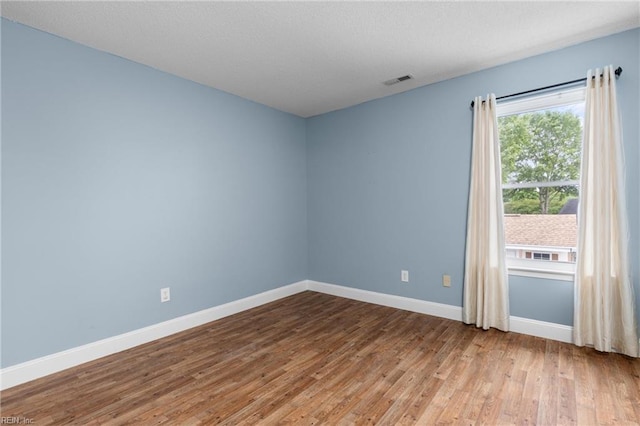 401 Fire Box Ct, Chesapeake, VA 23323 - unfurnished room featuring wood finished floors, baseboards, and a textured ceiling
