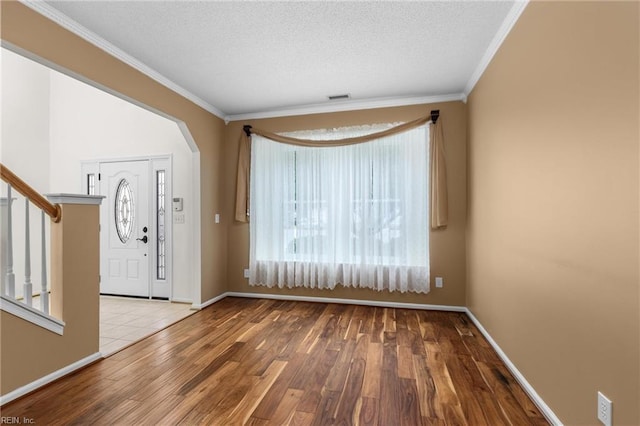 401 Fire Box Ct, Chesapeake, VA 23323 - entrance foyer with wood finished floors, ornamental molding, a textured ceiling, stairway, and arched walkways