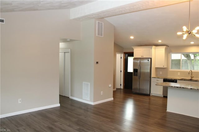 5857 Frament Ave, Norfolk, VA 23502 - kitchen with stainless steel appliances, lofted ceiling, white cabinets, a chandelier, and light stone counters