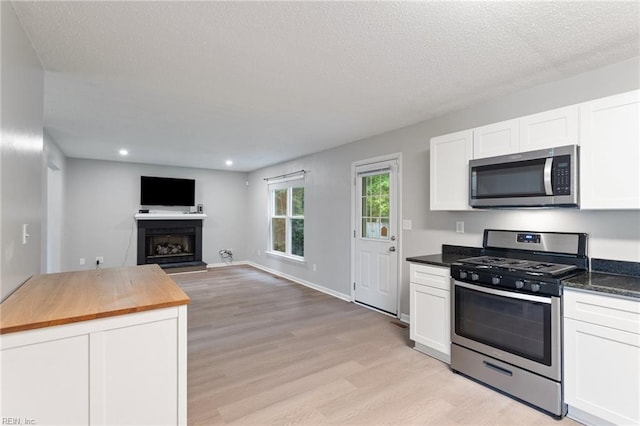 6218 Whaley Ct, Norfolk, VA 23502 - kitchen featuring appliances with stainless steel finishes, butcher block counters, light wood-style floors, white cabinets, and recessed lighting
