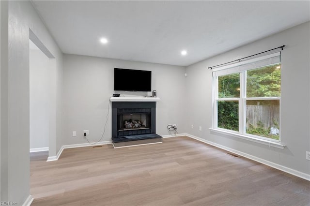 6218 Whaley Ct, Norfolk, VA 23502 - unfurnished living room featuring light wood-style flooring, a fireplace with raised hearth, baseboards, and recessed lighting
