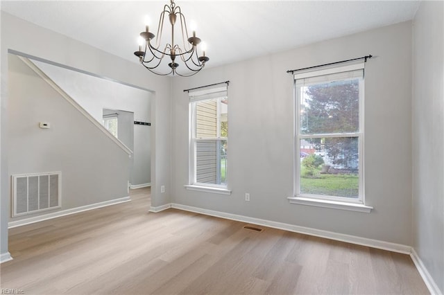 6218 Whaley Ct, Norfolk, VA 23502 - unfurnished dining area with wood finished floors, a chandelier, healthy amount of natural light, and baseboards