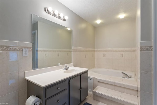 6218 Whaley Ct, Norfolk, VA 23502 - bathroom with vanity, a bath, a textured ceiling, tile patterned floors, and a wainscoted wall
