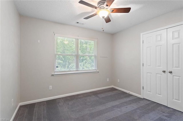 6218 Whaley Ct, Norfolk, VA 23502 - unfurnished bedroom with dark carpet, a textured ceiling, a closet, baseboards, and ceiling fan