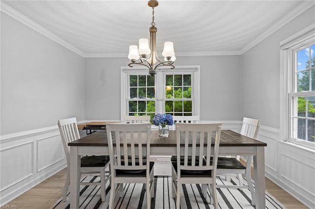 1321 Laurelfield Ct, Virginia Beach, VA 23454 - dining area featuring a chandelier, light wood-type flooring, ornamental molding, a decorative wall, and a wainscoted wall