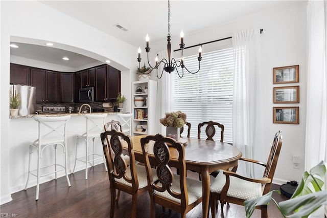 5516 Sadie Ln, Virginia Beach, VA 23462 - dining area featuring arched walkways, a chandelier, dark wood-type flooring, recessed lighting, and baseboards