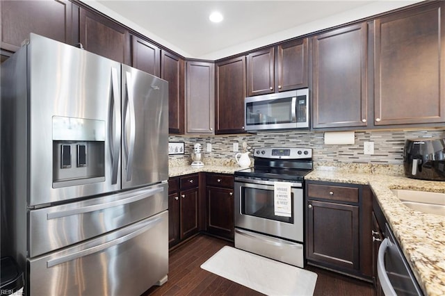 5516 Sadie Ln, Virginia Beach, VA 23462 - kitchen featuring appliances with stainless steel finishes, dark brown cabinets, dark wood-style flooring, decorative backsplash, and recessed lighting