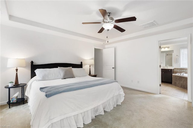 5516 Sadie Ln, Virginia Beach, VA 23462 - bedroom with a tray ceiling, light colored carpet, baseboards, and ensuite bath