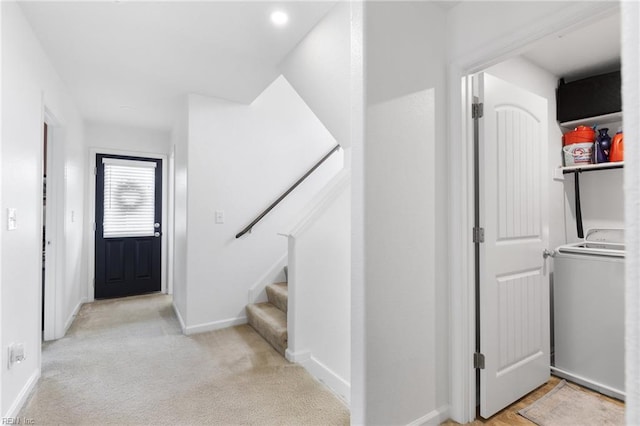 5516 Sadie Ln, Virginia Beach, VA 23462 - entrance foyer with washer / dryer, stairs, light colored carpet, and baseboards