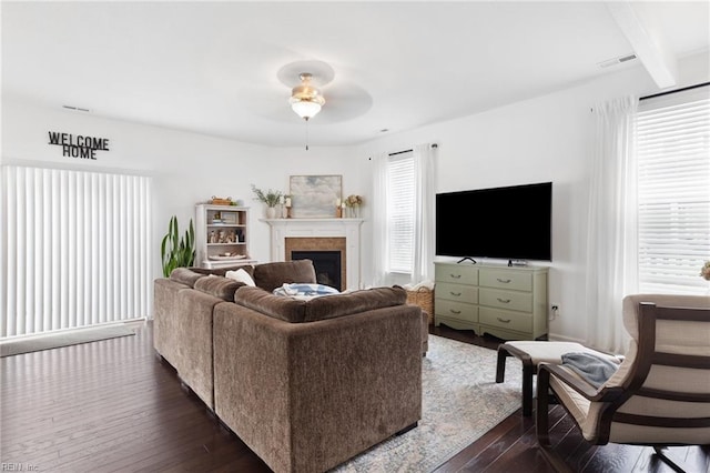 5516 Sadie Ln, Virginia Beach, VA 23462 - living room with dark wood-style flooring, a ceiling fan, a fireplace, and beamed ceiling