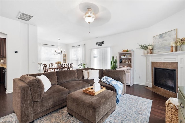 5516 Sadie Ln, Virginia Beach, VA 23462 - living room with dark wood-style floors, a ceiling fan, a fireplace, a chandelier, and baseboards