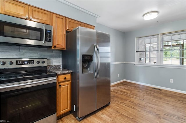 2 Sheralyn Pl, Hampton, VA 23666 - kitchen with appliances with stainless steel finishes, light wood-style floors, decorative backsplash, baseboards, and brown cabinets
