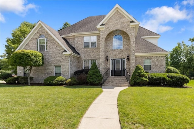 1605 Pierside Lndg, Chesapeake, VA 23321 - view of front facade with brick siding, a front yard, and roof with shingles