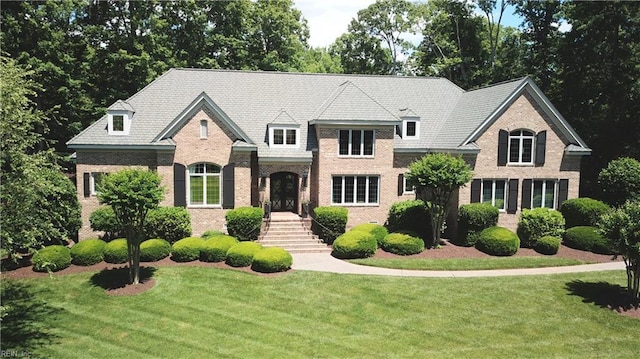 1909 N Fowlers Close Close, Williamsburg, VA 23185 - french country home featuring a front lawn and brick siding