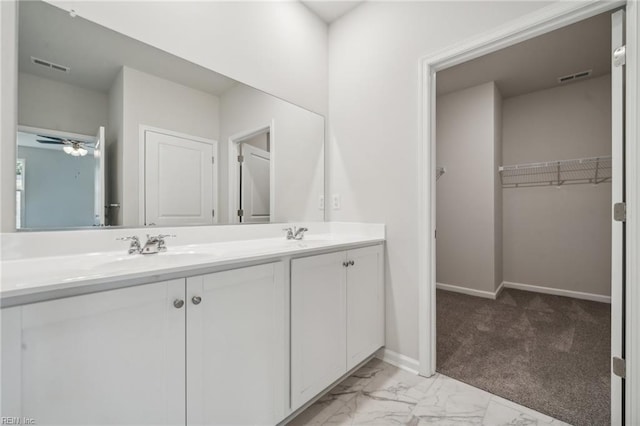 3032 Dalton Cir, Suffolk, VA 23435 - bathroom featuring double vanity, marble finish flooring, a spacious closet, a ceiling fan, and baseboards