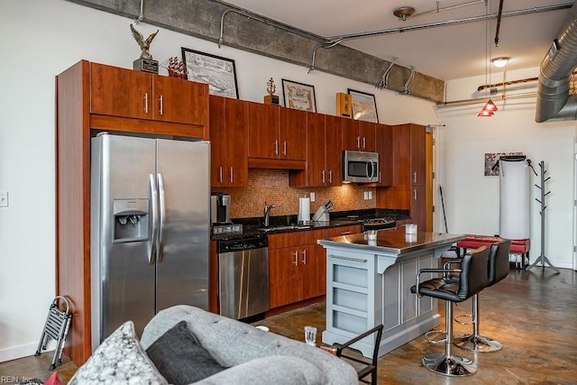 415 Saint Pauls Blvd Unit 309, Norfolk, VA 23510 - kitchen with stainless steel appliances, tasteful backsplash, a sink, a kitchen island, and a kitchen breakfast bar
