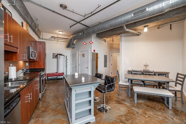 415 Saint Pauls Blvd Unit 309, Norfolk, VA 23510 - kitchen with appliances with stainless steel finishes, brown cabinets, dark countertops, unfinished concrete flooring, and electric panel